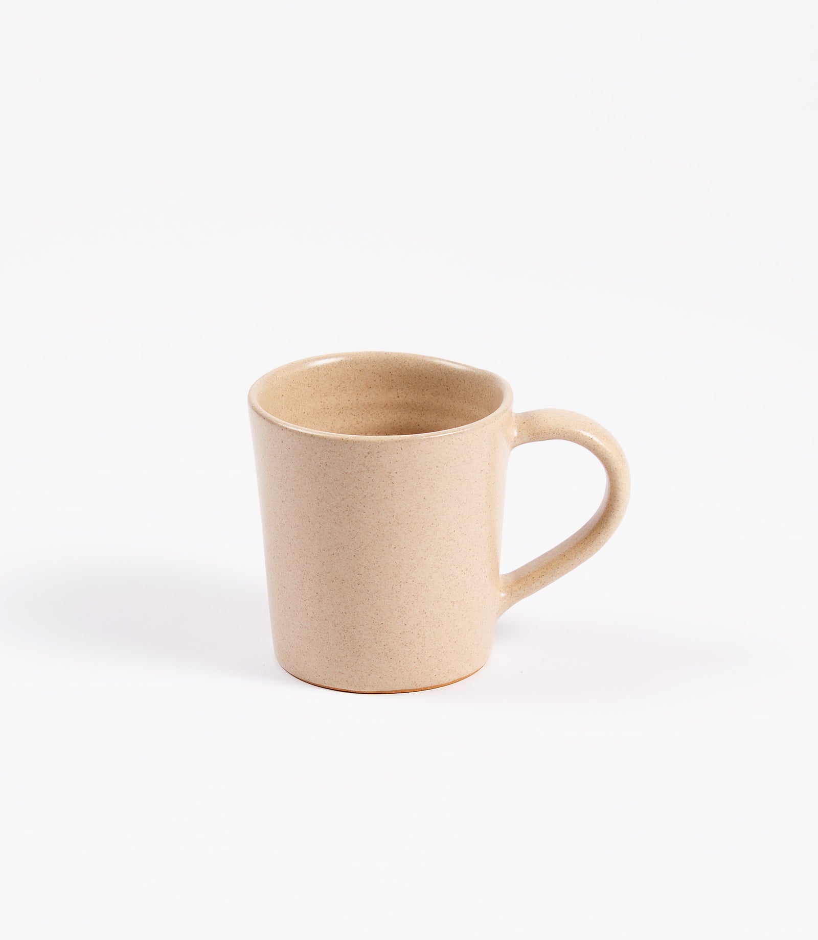 Beige ceramic mug on a white background