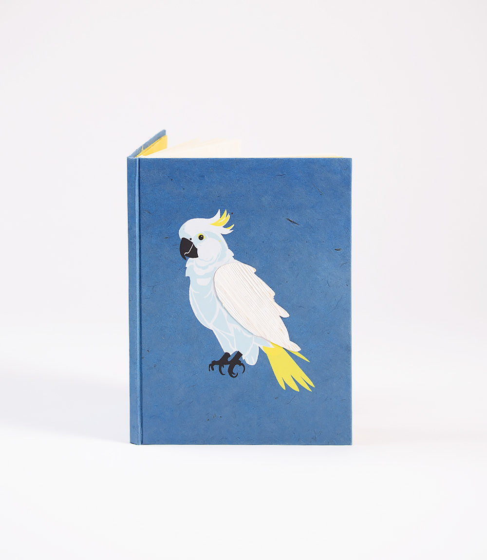 Notebook with a white parrot illustration on a blue background