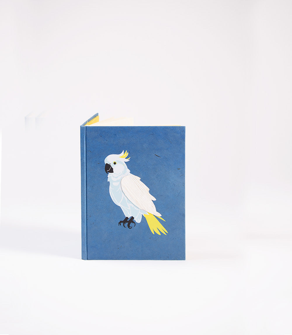 Notebook with a white cockatoo illustration on a blue background