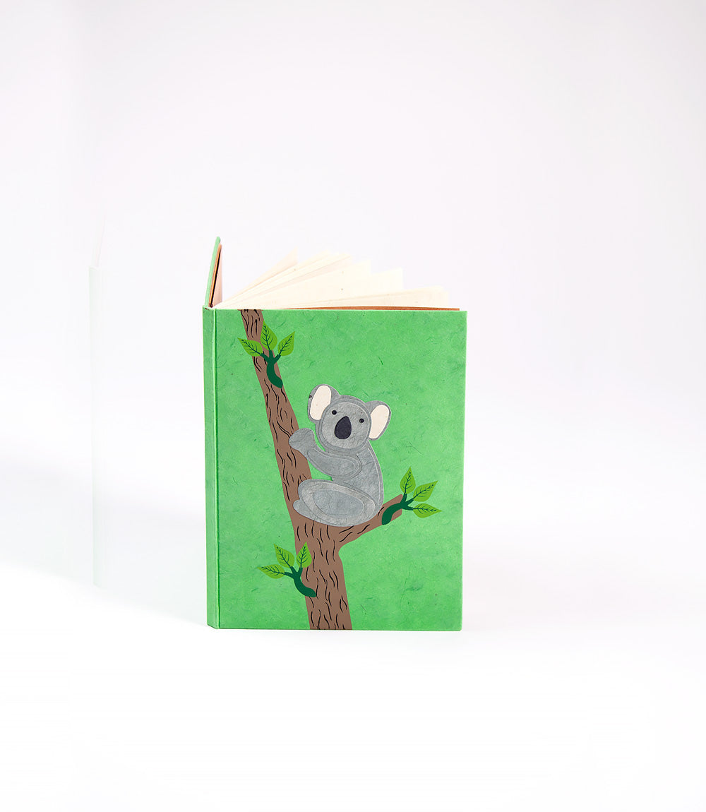 Notebook with a koala illustration on a green cover against a white background