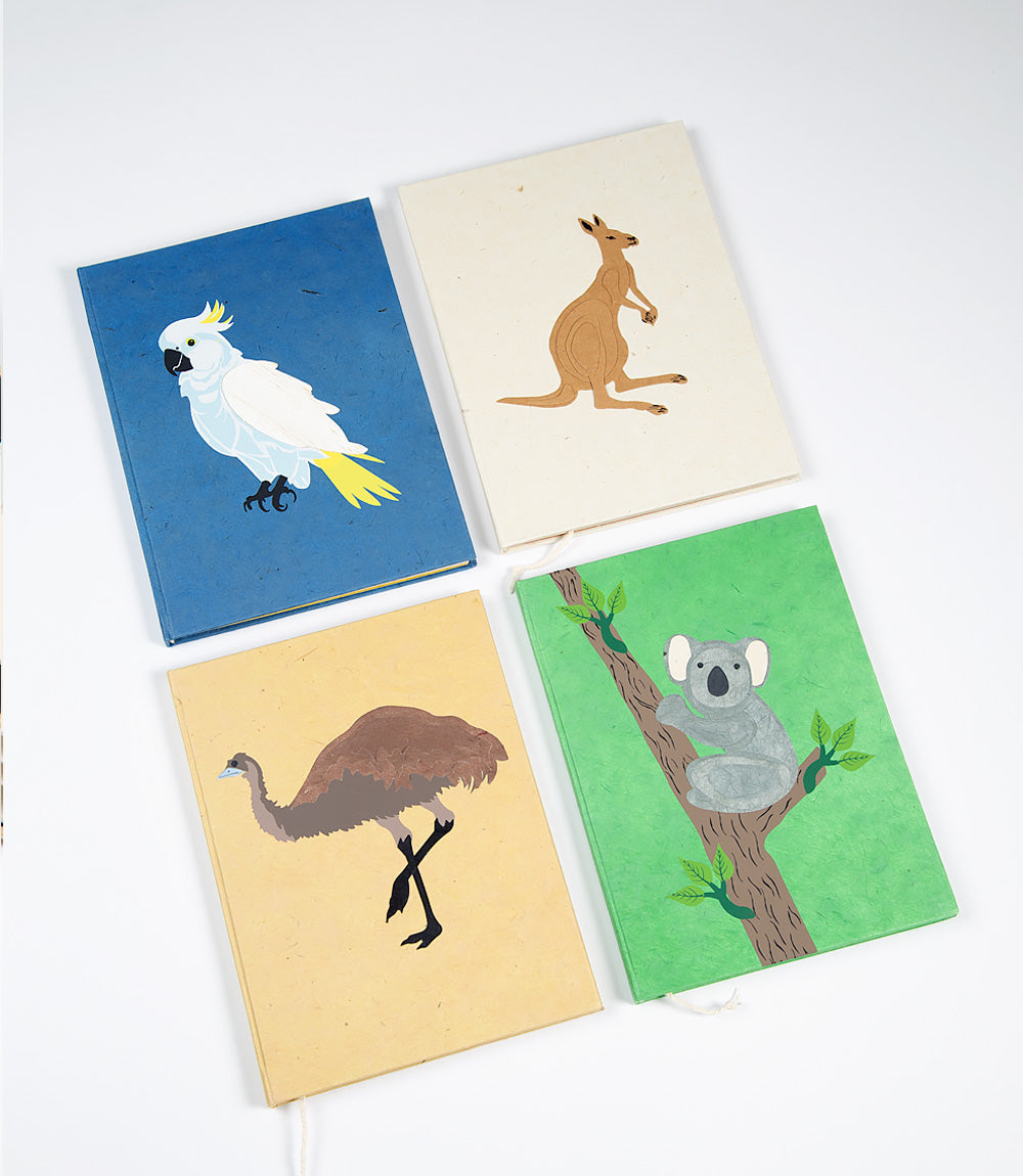 Four notebooks with animal illustrations on a white background