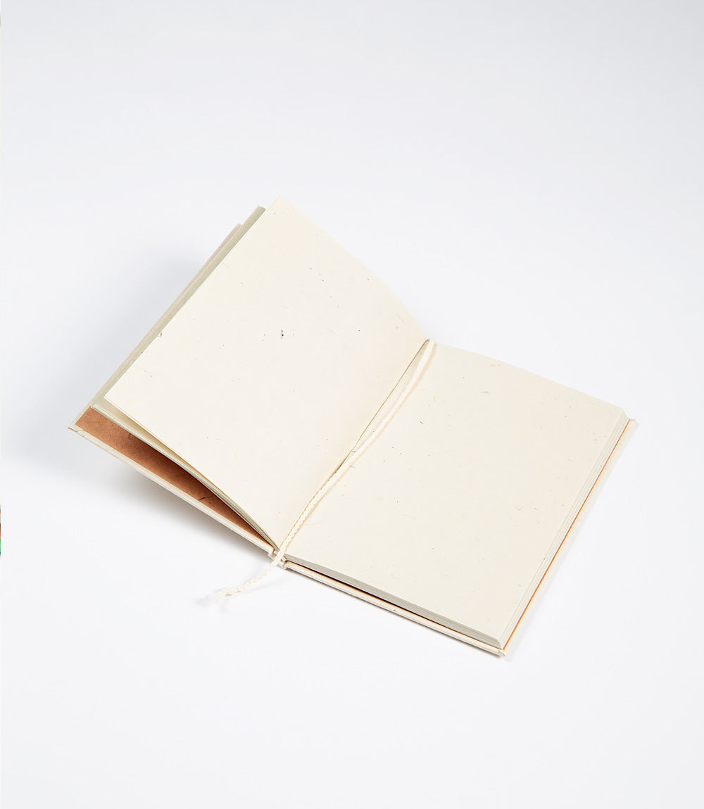 Open notebook with cream-colored pages on a white background