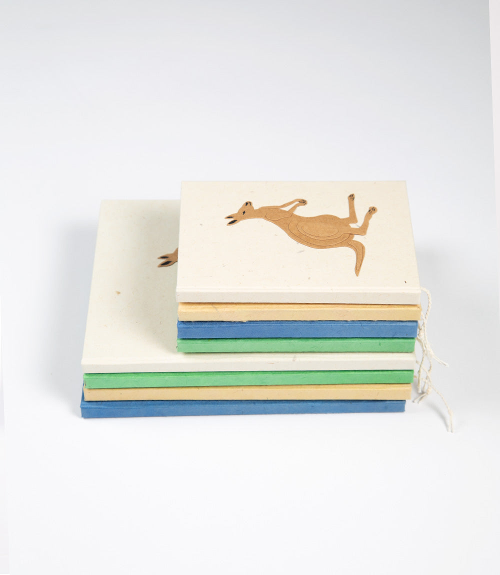 Stack of colorful books with a kangaroo illustration on a white background