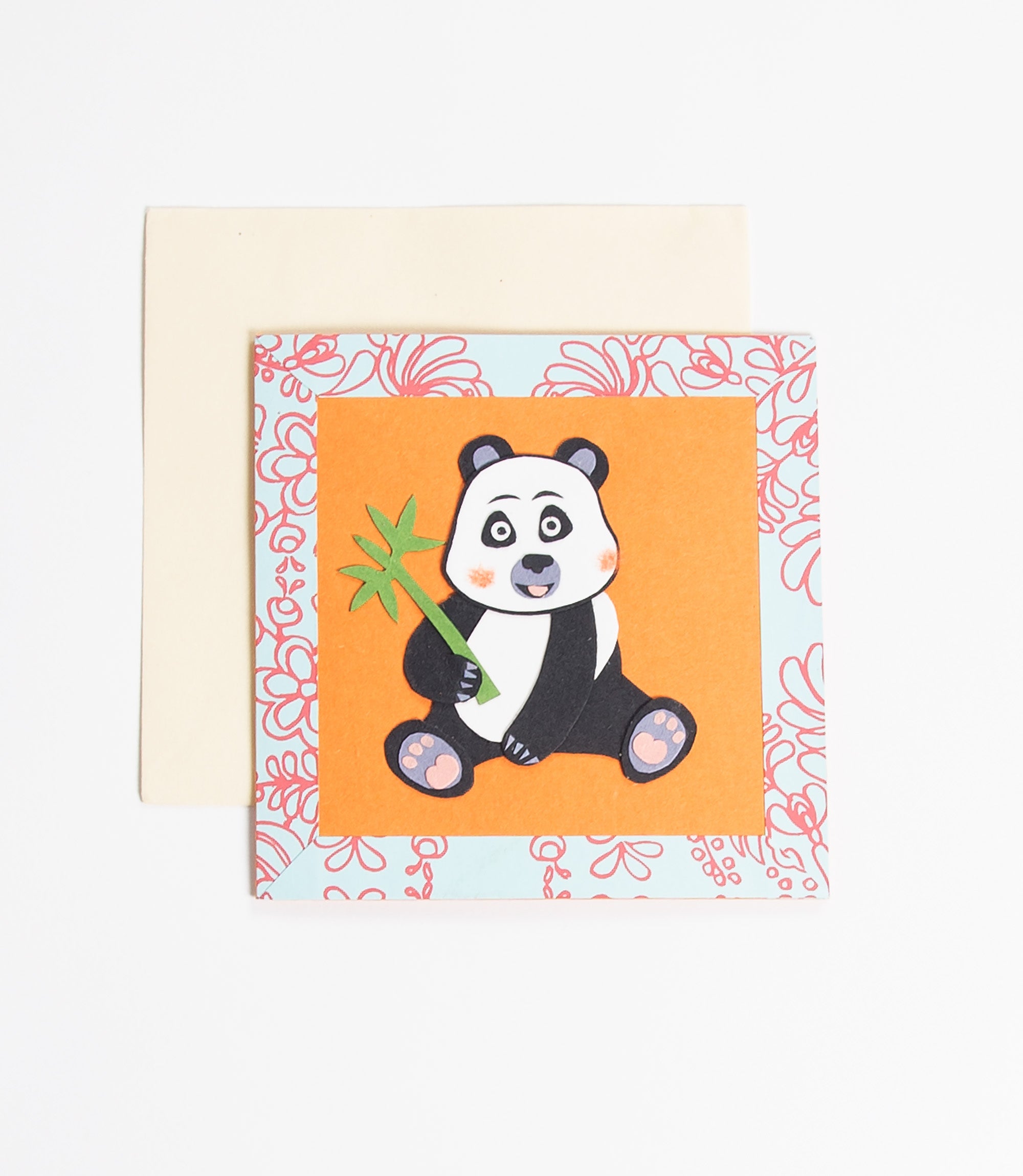 Card with a panda holding a bamboo stick on an orange background with floral border