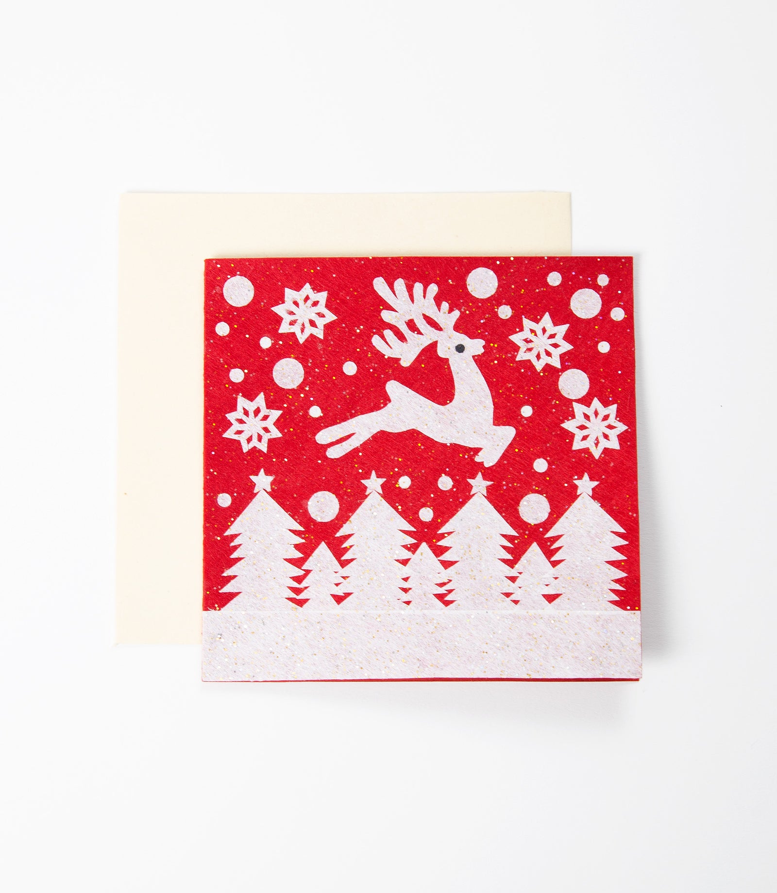 Red card with white reindeer and snowflake design. 