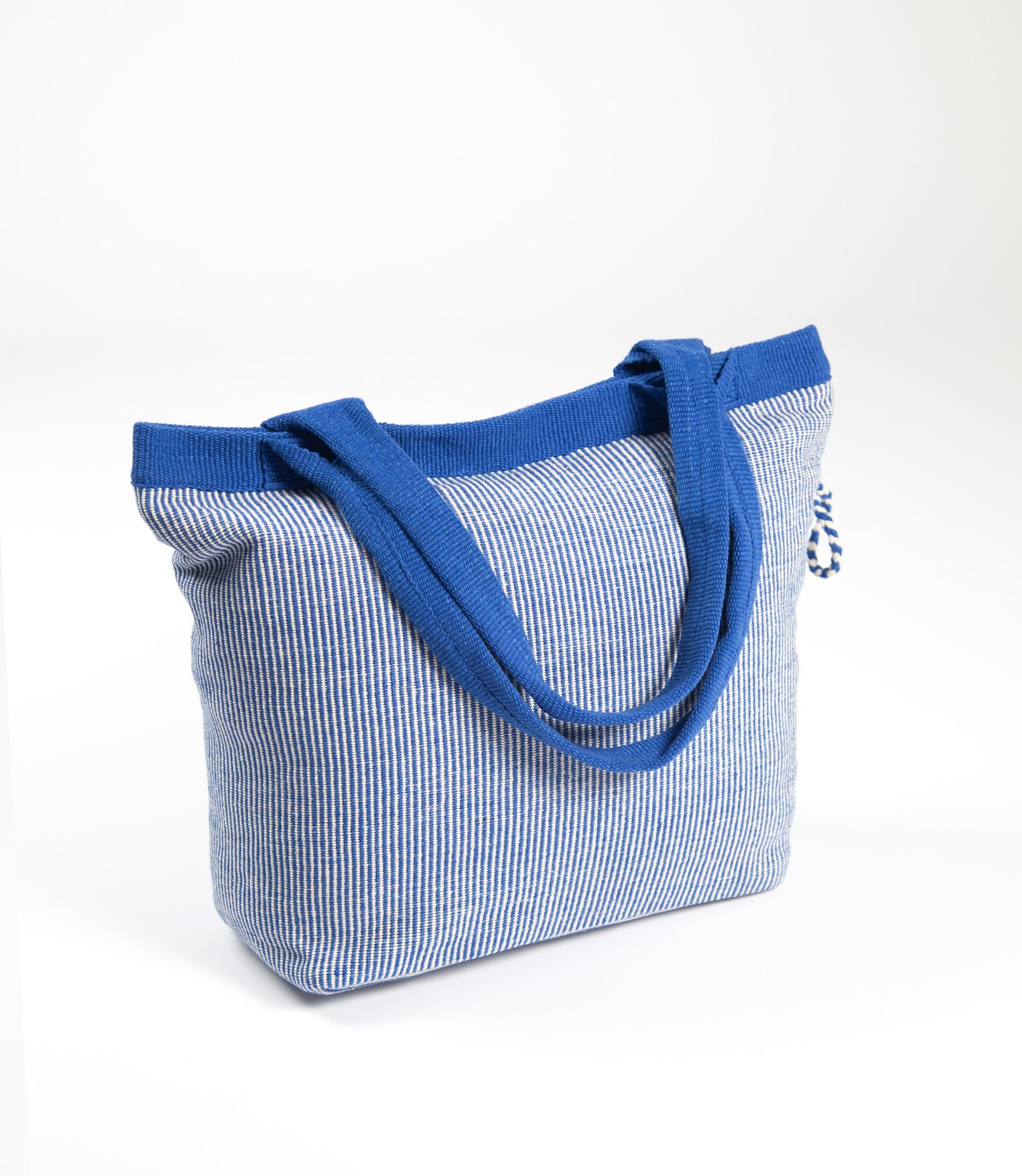 Blue and white striped tote bag with blue handle on a white background