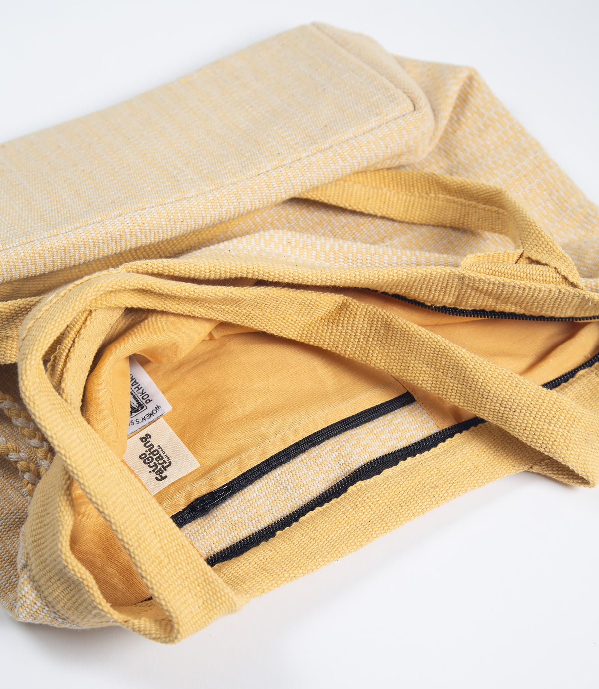 Yellow fabric bag with a tag on a white background