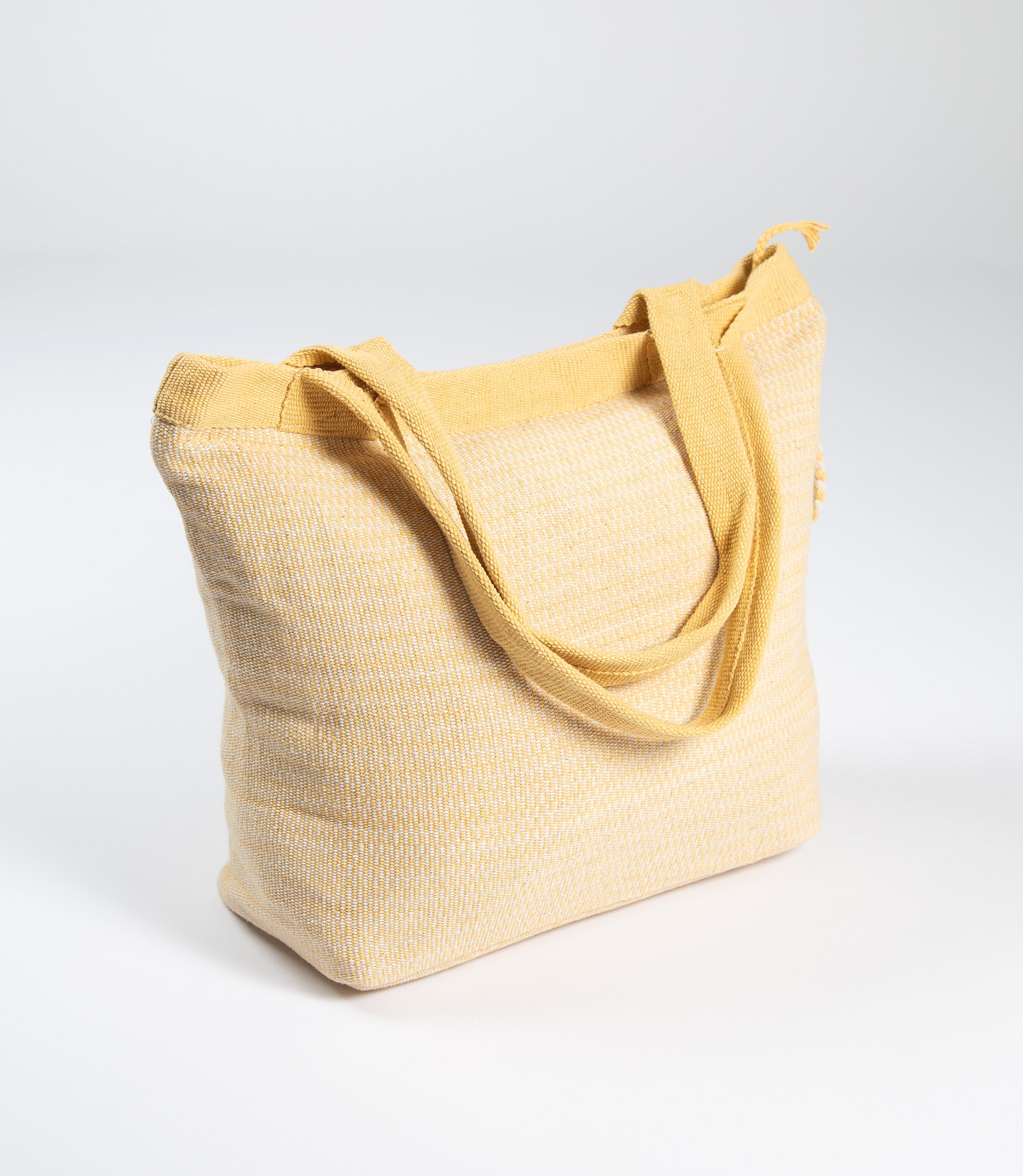 Yellow tote bag with textured surface on a white background