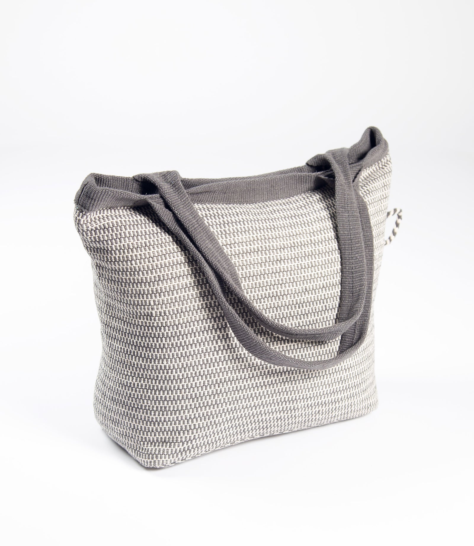 Woven handbag with gray handle on a white background