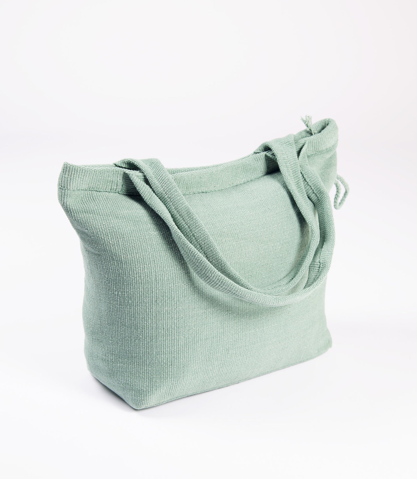 Green textured shoulder bag on a white background