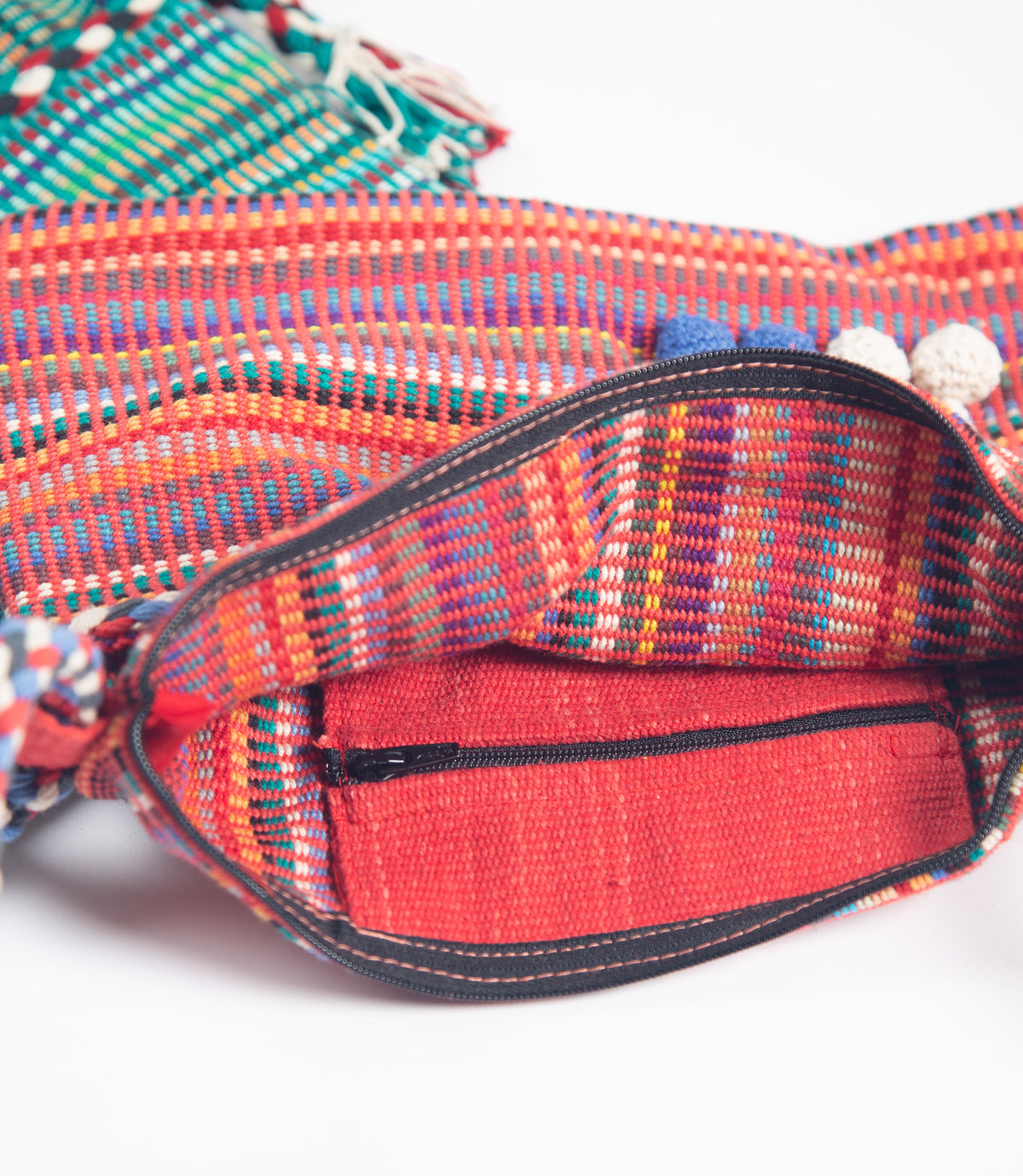 Colorful woven bag with a red interior on a white background