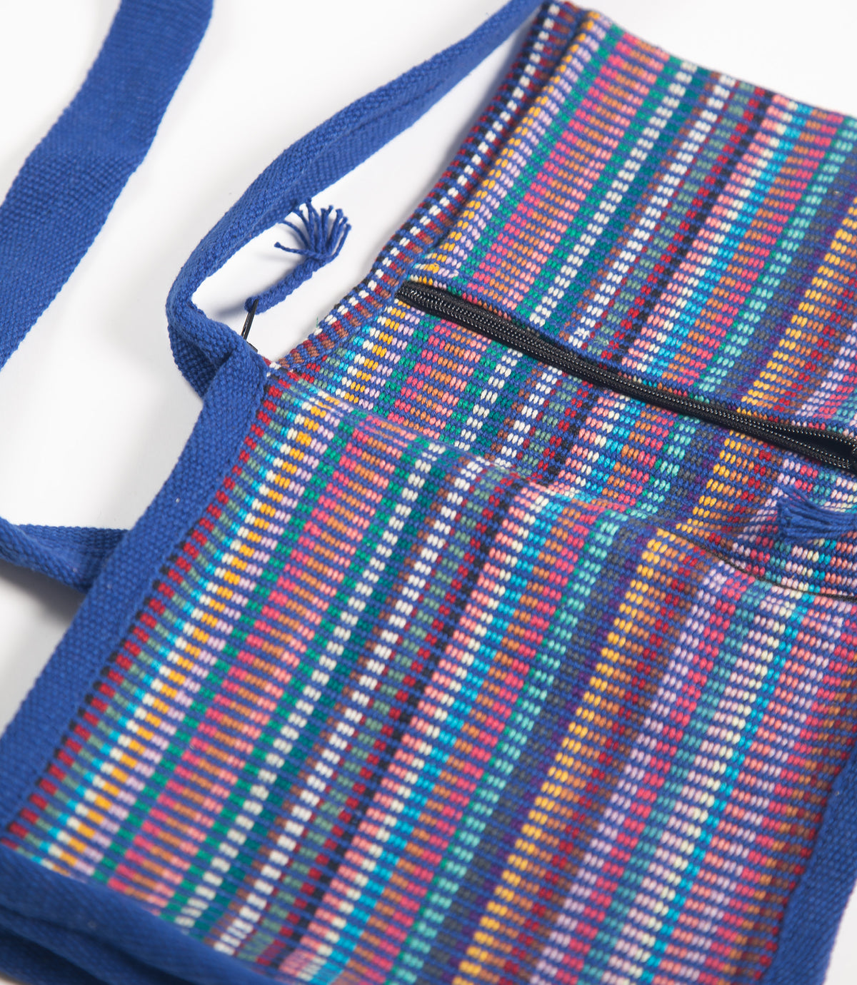 Colorful striped bag with blue handles on a white background