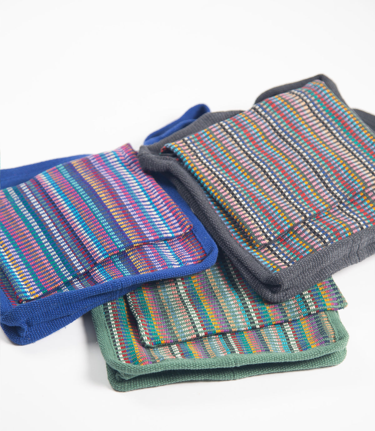 Colorful striped fabric bags on a white background