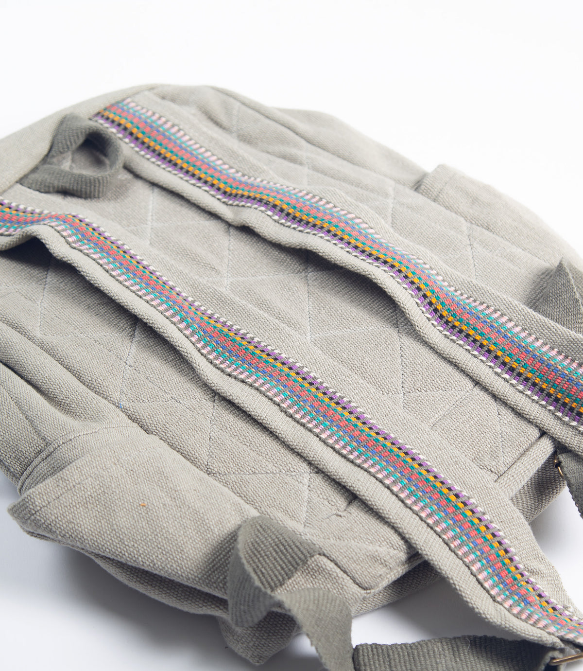 Gray bag with colorful woven strap on a white background