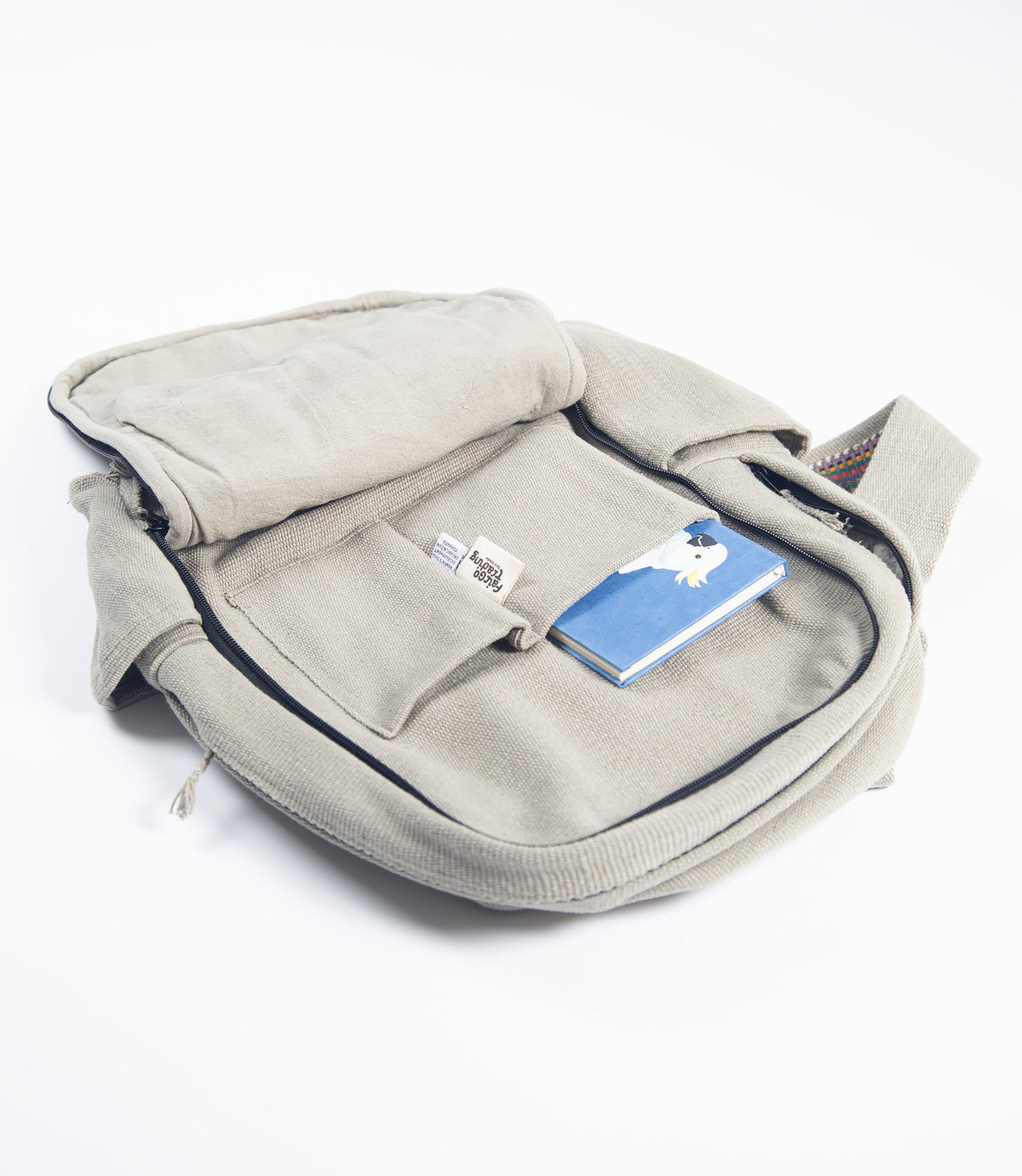 Open light grey backpack showing a notebook fitted in a n inside pocket