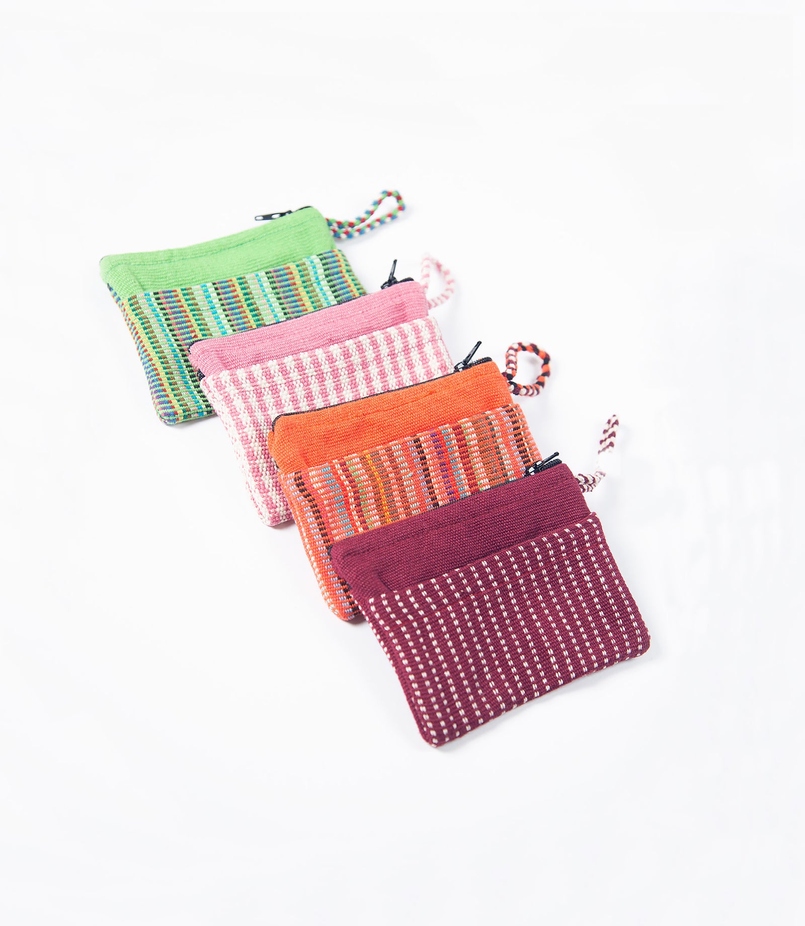 Set of colorful fabric pouches with zippers on a white background