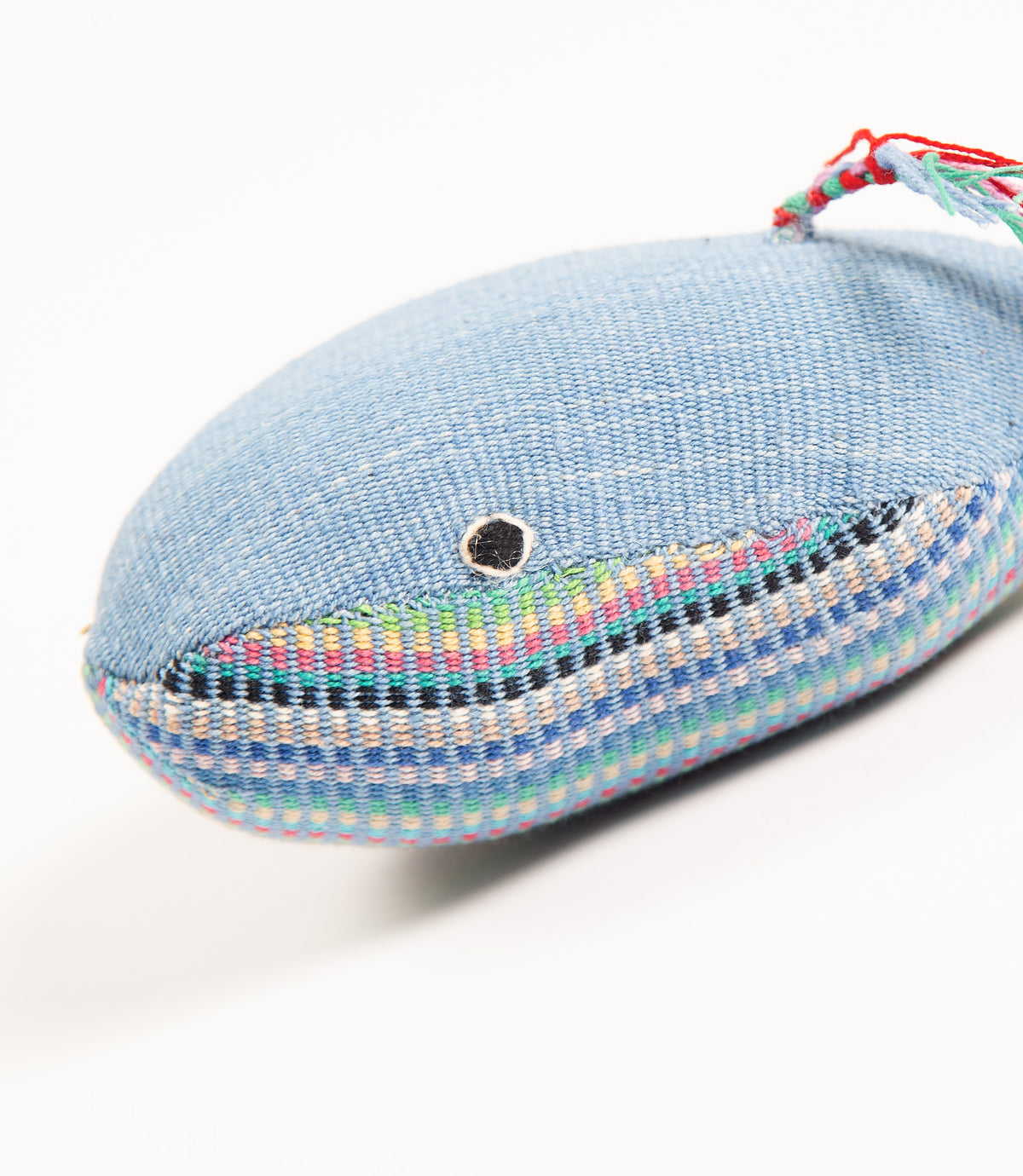 Blue whale-shaped toy with colorful details on a white background