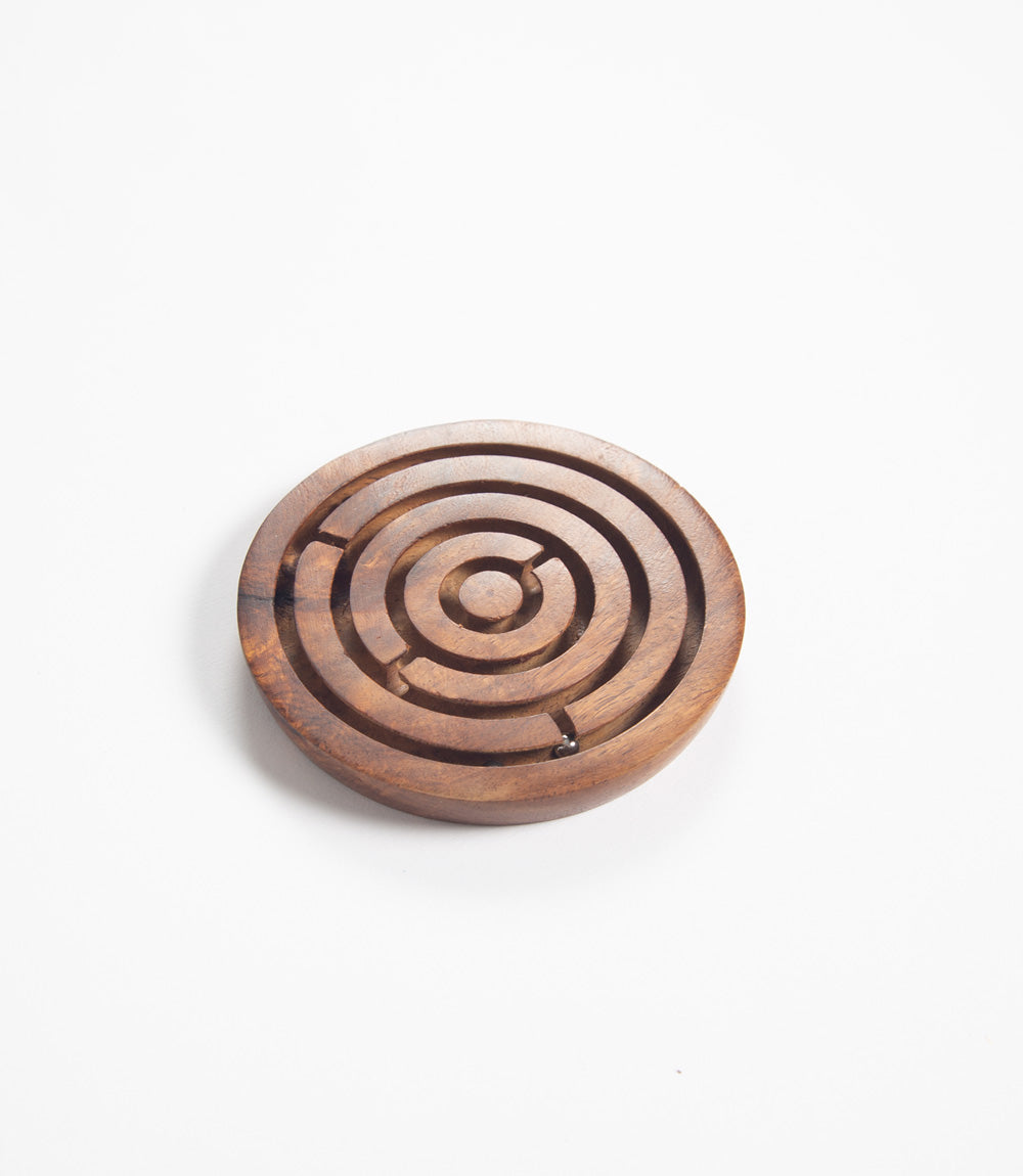 Wooden labyrinth puzzle on a white background