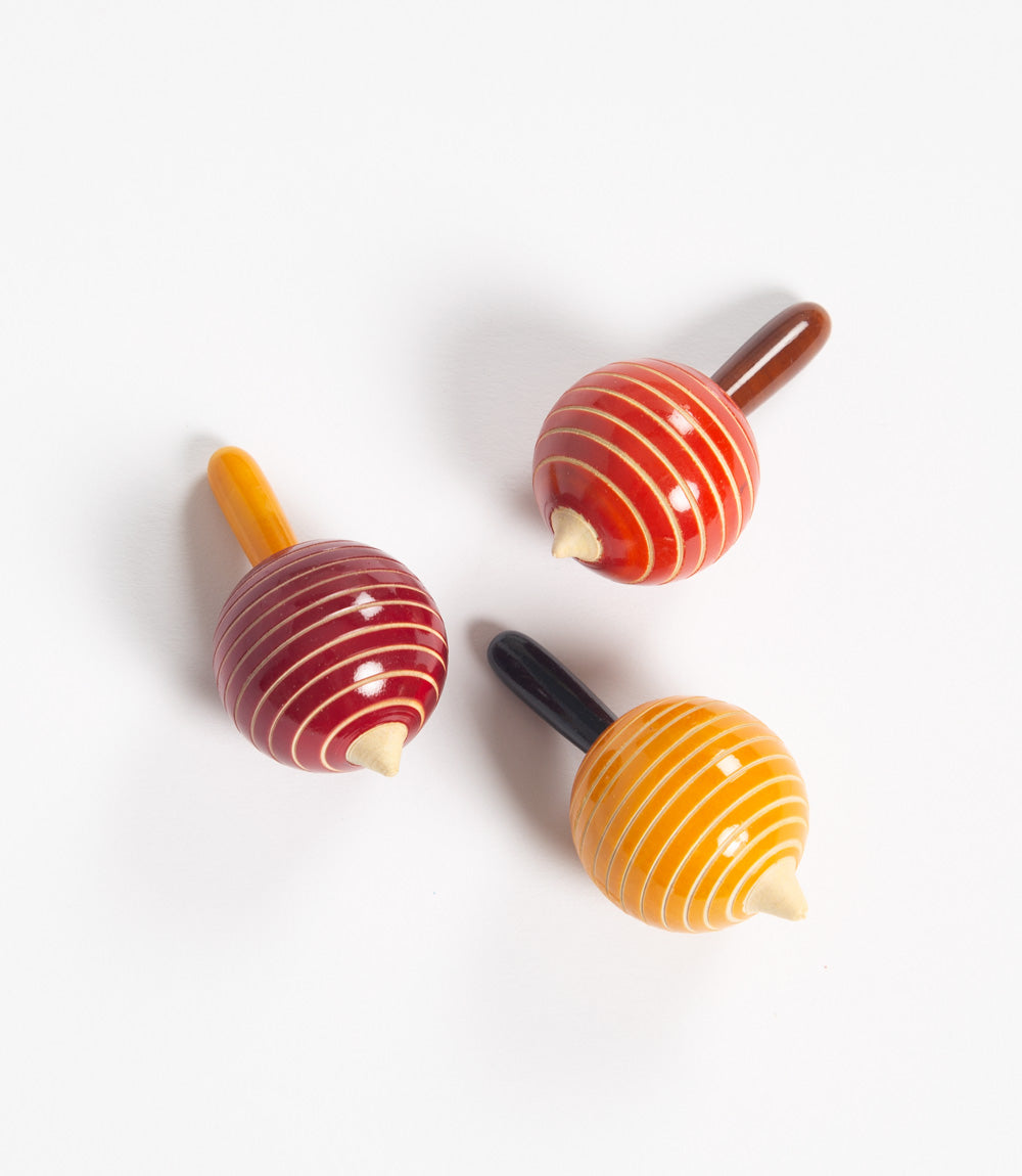 Set of three colorful wooden spinning tops.