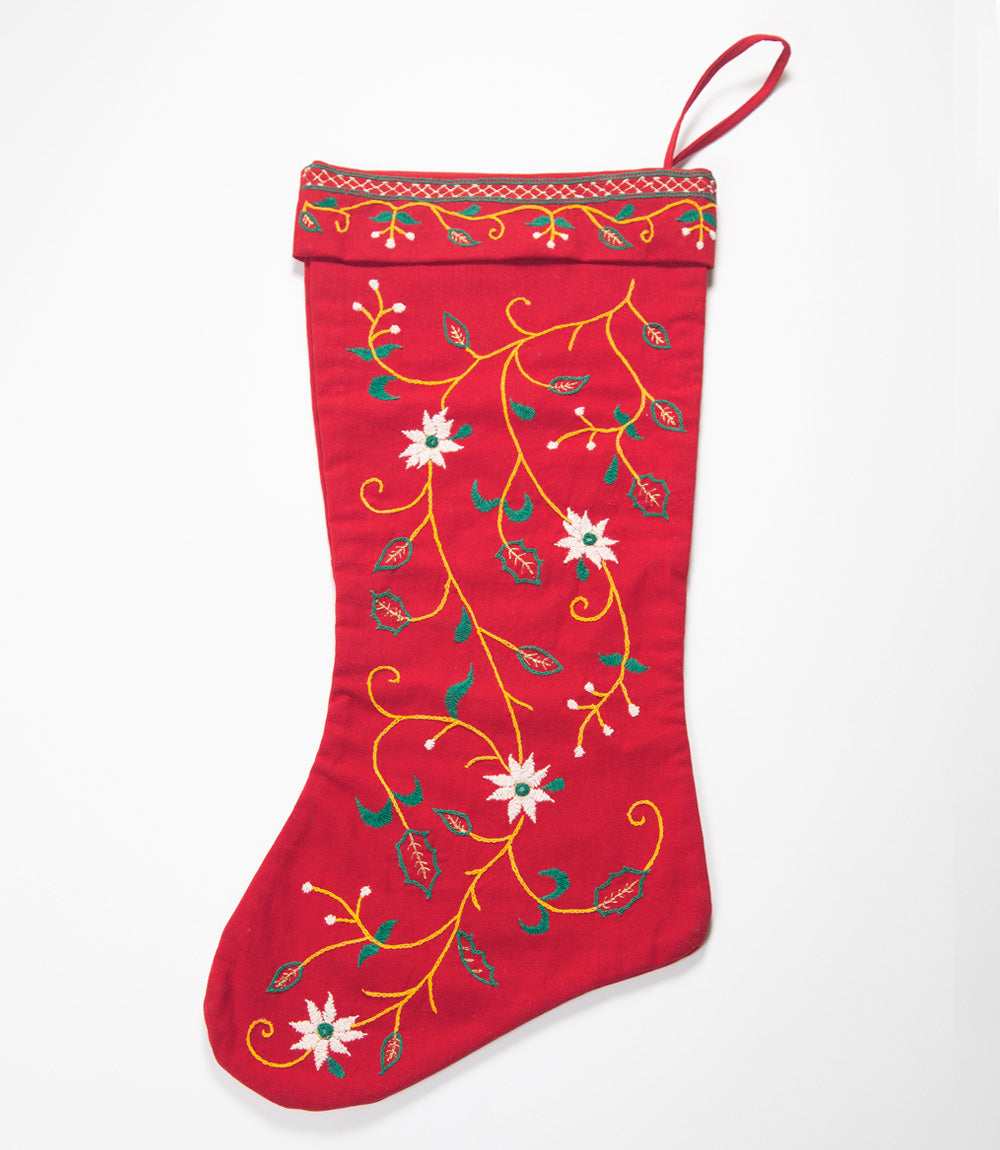 Red Christmas stocking with floral patterns on a white background