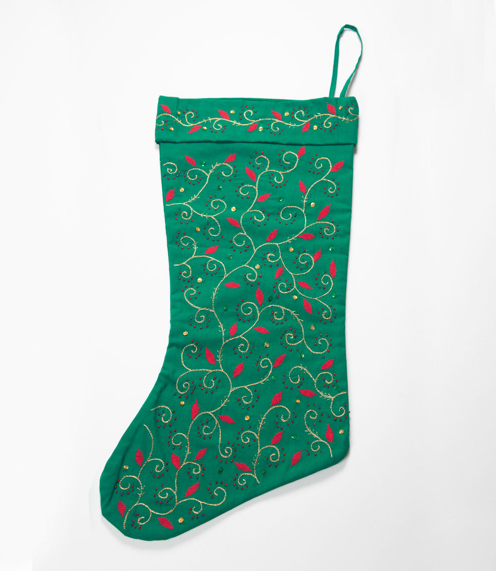 Green Christmas stocking with decorative patterns on a white background